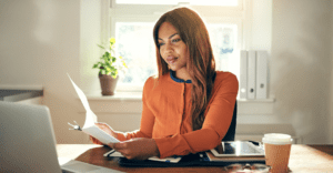 A renewable energy legal professional reviews papers at their desk. Taylor Hopkinson specialises in connecting legal specialists to pioneering projects globally.