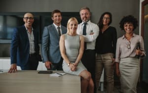 A group of business professionals standing for a team photo