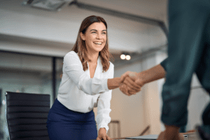 Business woman shaking hands with a colleague