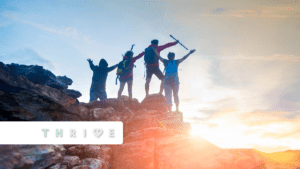 Four hikers standing at the peak of a hill featuring the Thrive logo