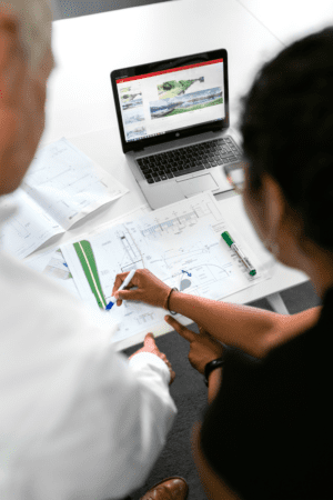 IT Engineering specialist working on plans with coworker