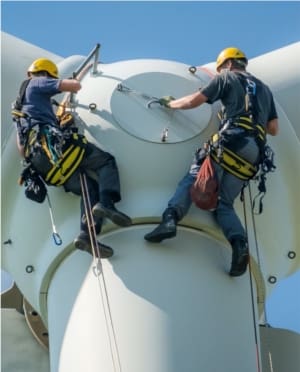 Two wind energy specialist working on a turbine