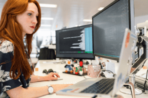 A renewables digital specialist at work on two screens.