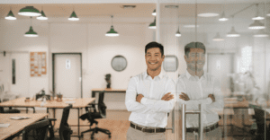 A renewables professional in a white shirt smiling in an office.